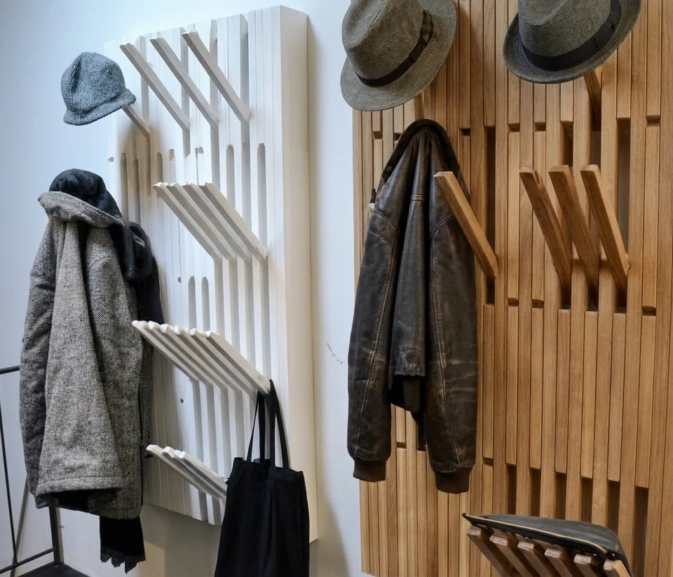 Slatted wall-mounted coat rack with jackets and hats